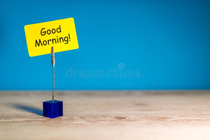 Good morning - wish for a good day. Note at yellow paper at blue background. With empty space for text, mockup and template.