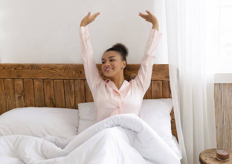 https://thumbs.dreamstime.com/b/good-morning-world-well-rested-african-american-woman-sitting-stretching-comfy-bed-raising-hands-up-smiling-enjoying-237335707.jpg