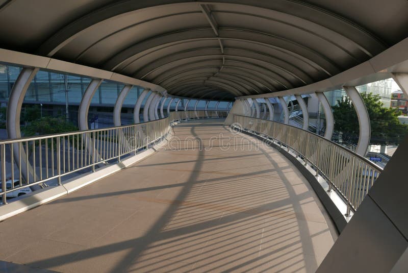 A good scenery to take fence`s shadows shading on the walk way of a well build bridge. A good scenery to take fence`s shadows shading on the walk way of a well build bridge.