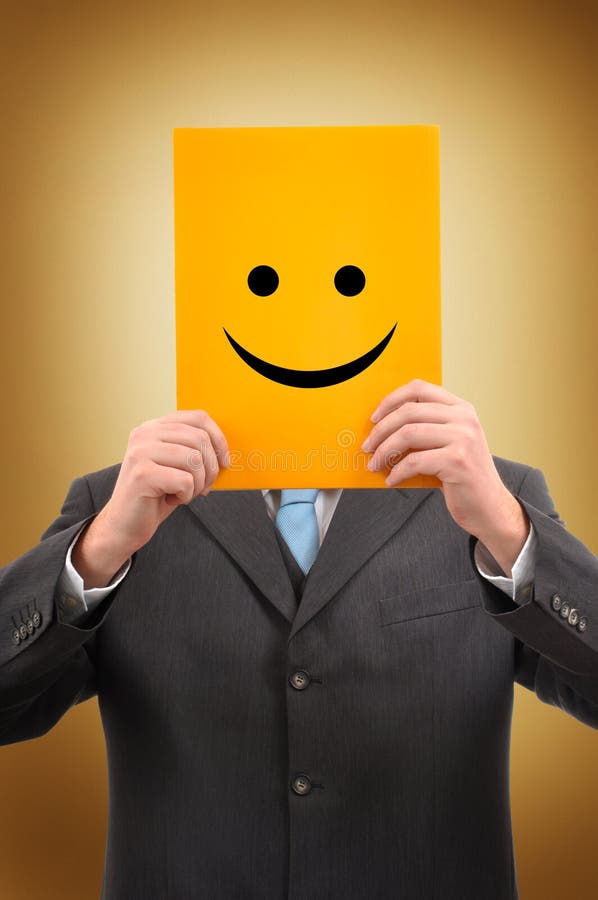 Businessman in gray suite is holding a yellow folder with happy face drawn on it. Businessman in gray suite is holding a yellow folder with happy face drawn on it
