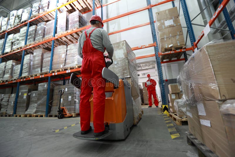 Goods delivery - two workers working in storehouse with forklift loader. Goods delivery - two workers working in storehouse with forklift loader