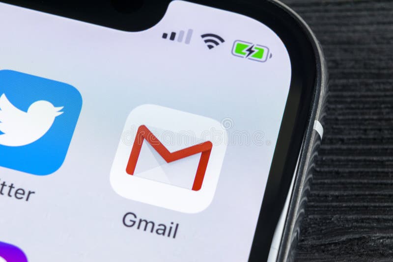 Google Gmail application icon on Apple iPhone X smartphone screen close-up. Gmail app icon. Gmail is popular Internet online e-ma royalty free stock images