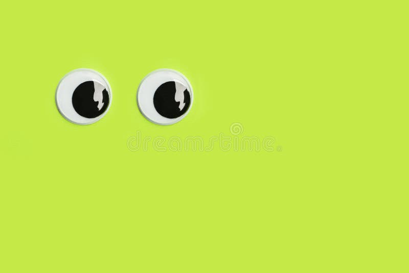 Googly Eyes on a Green Background with Copy Space Stock Image Image