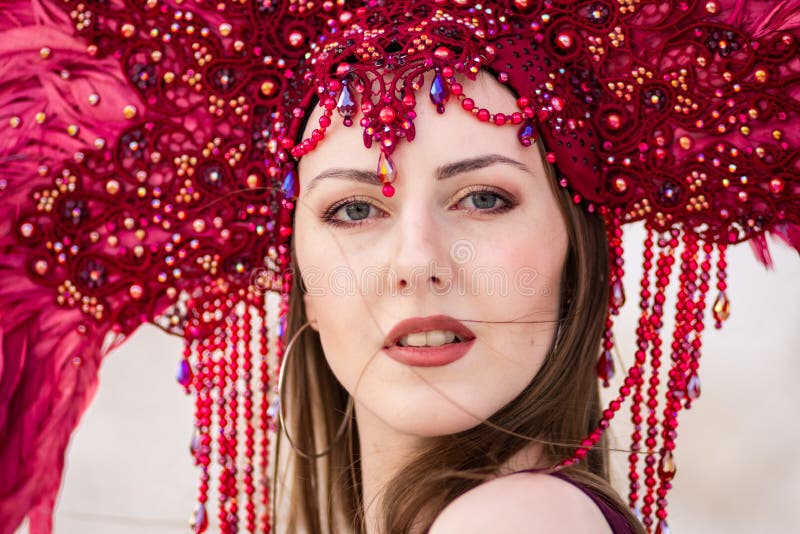 A Beautiful Young Woman in a Red Feather Crown Stock Image