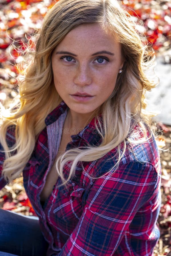 A Lovely Blonde Model Enjoys An Autumn Day Outdoors At The Park Stock