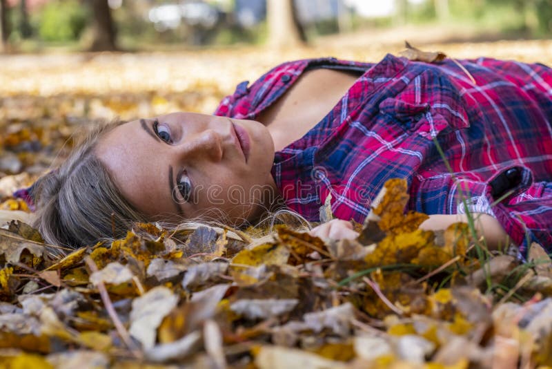 A Lovely Blonde Model Enjoys An Autumn Day Outdoors At The Park Stock