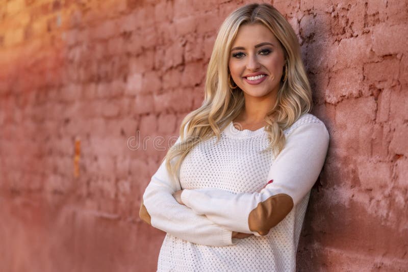 A Lovely Blonde Model Enjoys An Autumn Day Outdoors In A Small Town