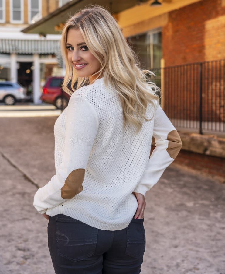 A Lovely Blonde Model Enjoys An Autumn Day Outdoors In A Small Town