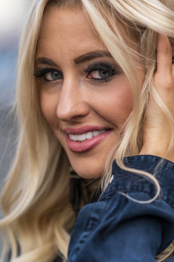 A Lovely Blonde Model Enjoys An Autumn Day Outdoors In A Small Town