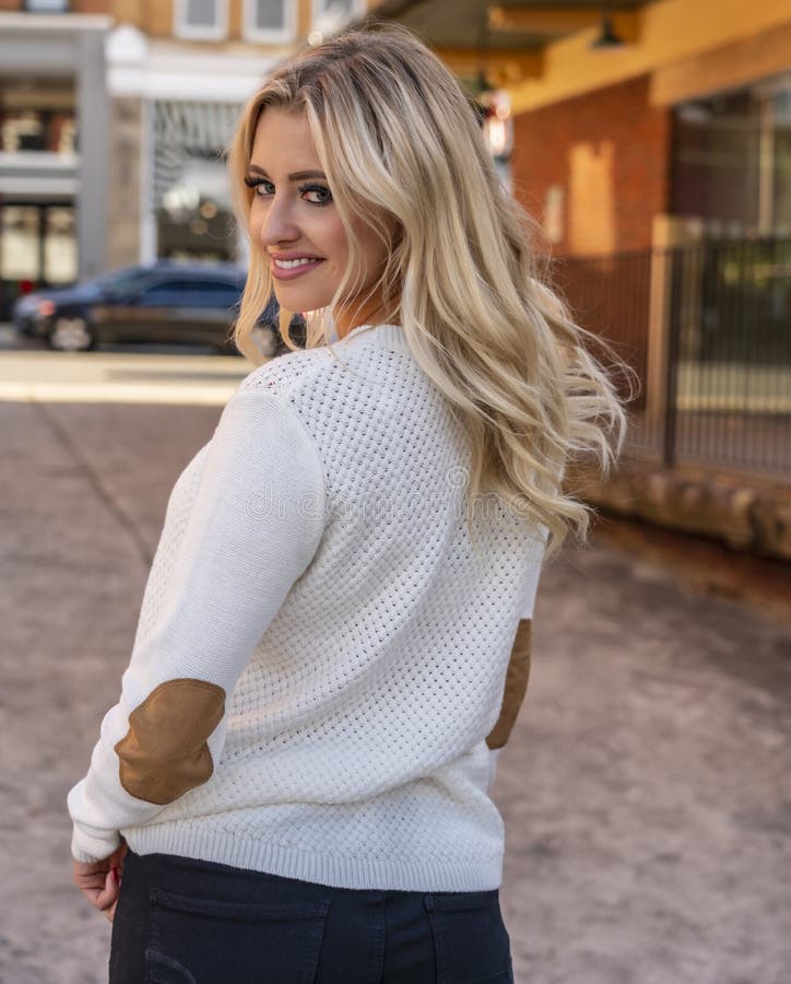 A Lovely Blonde Model Enjoys An Autumn Day Outdoors In A Small Town