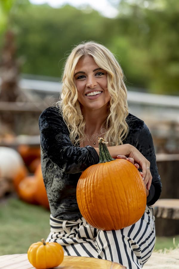 A Lovely Blonde Model Poses in a Pumpkin Field during the Halloween ...