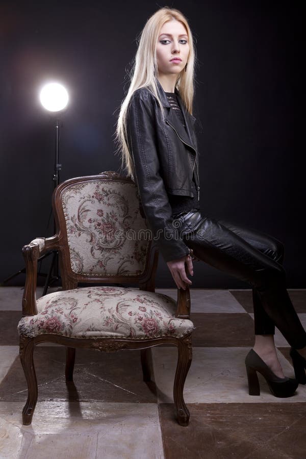 Gorgeous blonde sitting on a vintage chair