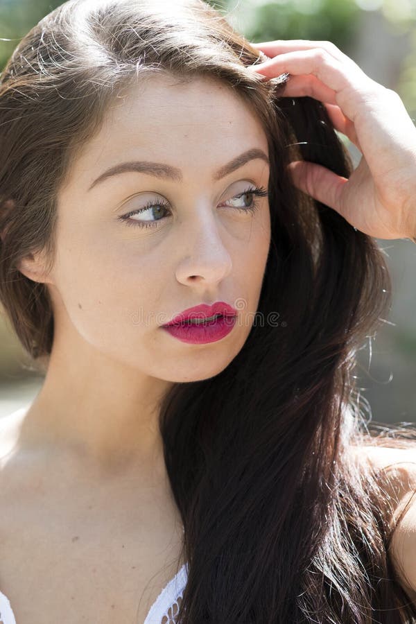 A Lovely Brunette Model Enjoys An Spring Day Outdoors Stock Image