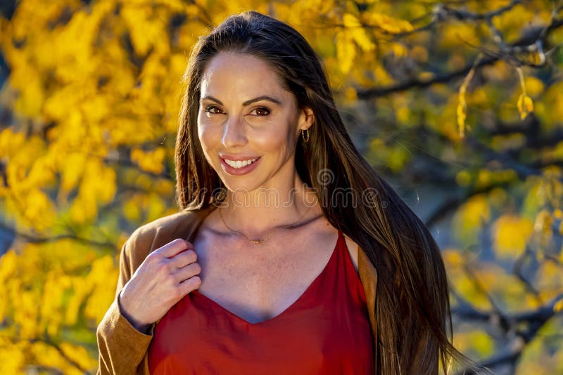 A Lovely Brunette Model Poses Outdoor While Enjoying The Fall Weather 