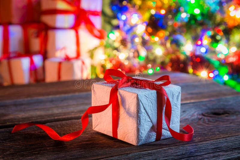 Christmas Present with Tree and Lights on Background Stock