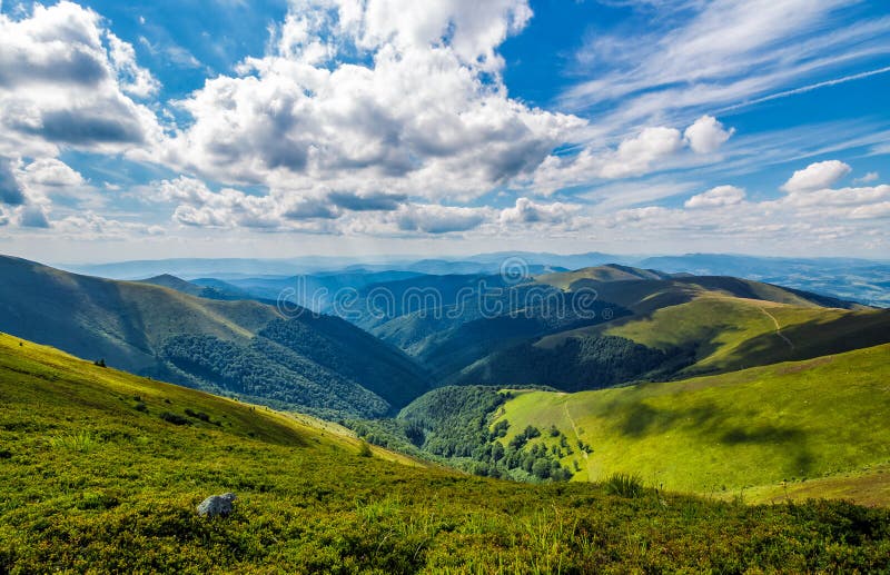 Gorgeous cloudscape over the grassy hillside stock photography