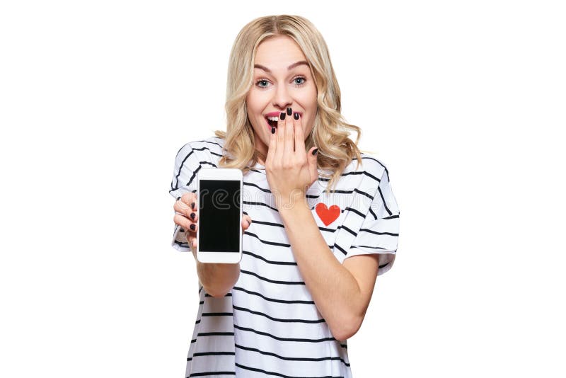 Gorgeous excited woman showing blank screen mobile phone over white background, celebrating victory and success. Very excited, cheering emotion. Gorgeous excited woman showing blank screen mobile phone over white background, celebrating victory and success. Very excited, cheering emotion.