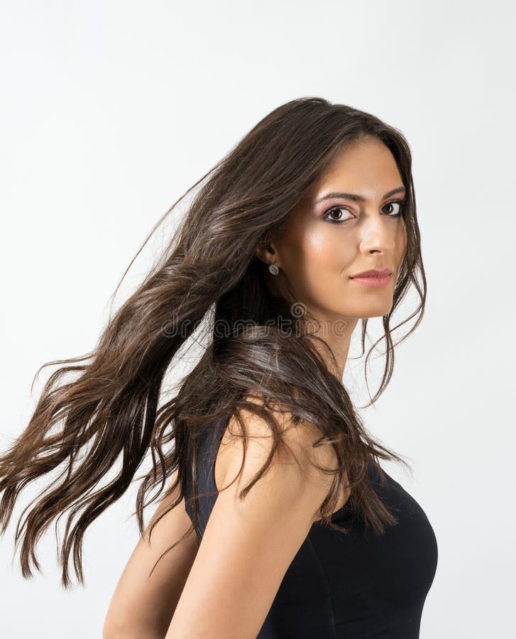 Gorgeous exotic tanned beauty with frozen motion of her long flowing hair royalty free stock photo Gorgeous exotic tanned beauty with frozen motion of her long flowing hair royalty free stock photo
