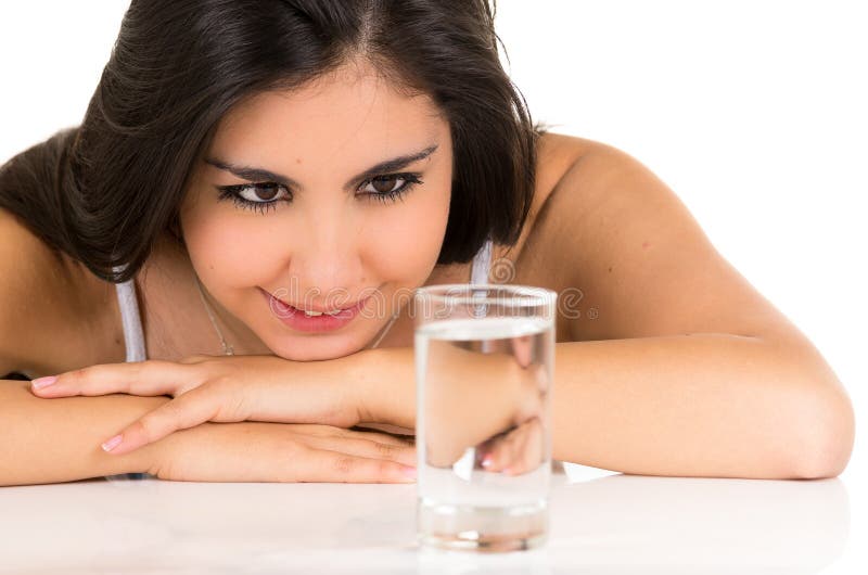 Gorgeous hispanic young girl smiling with a glass