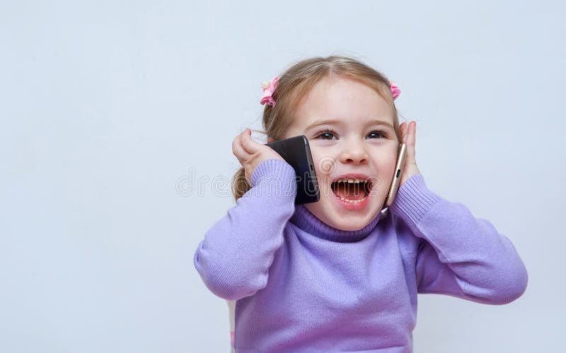 Gorgeous pretty girl ispeaks on the two phones royalty free stock photography Gorgeous pretty girl ispeaks on the two phones royalty free stock photography