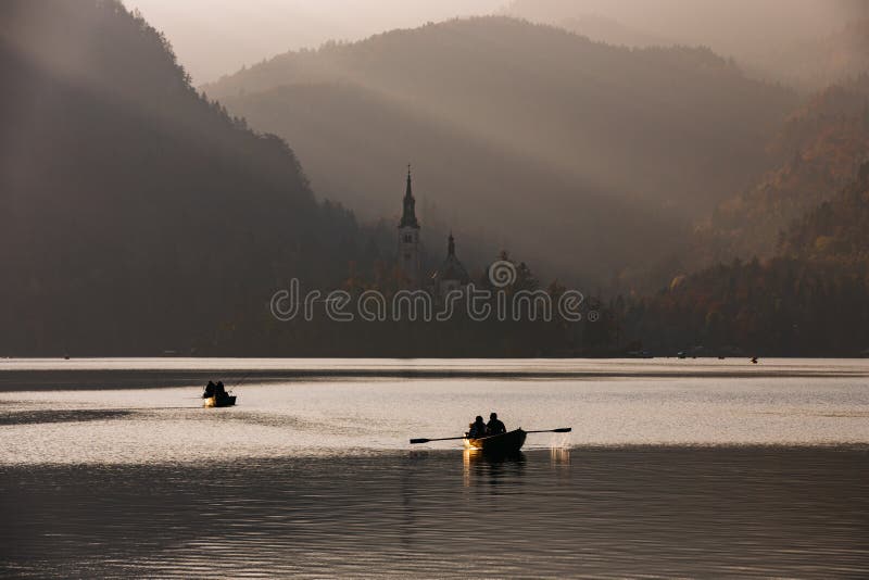 Bled Lake in the sunset with boat stock image Bled Lake in the sunset with boat stock image
