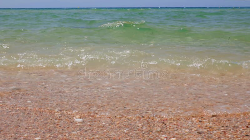 Gorgeous view of foamy waves on sand coast rolling on coast of  beach. Beautiful colorful nature landscape backgrounds.