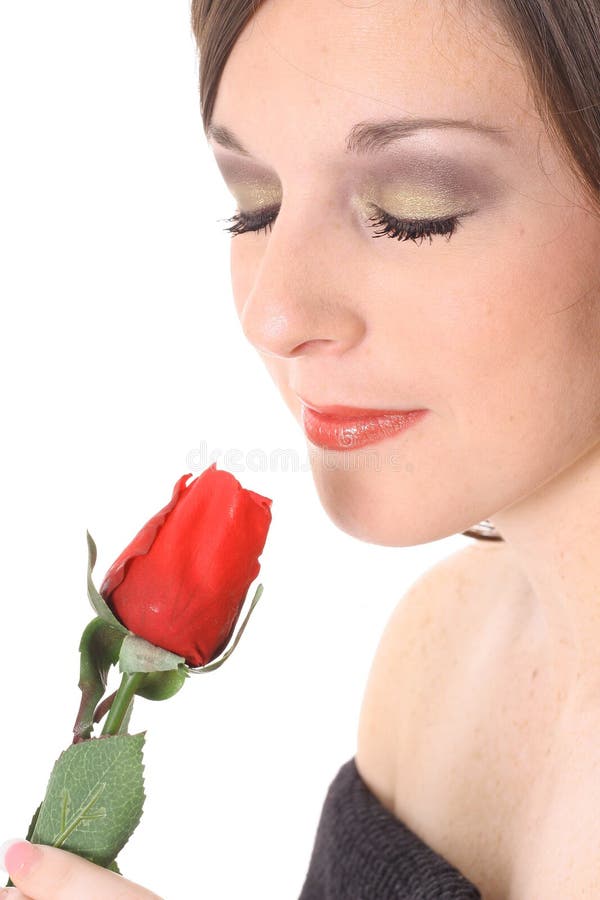 Gorgeous woman smelling a rose