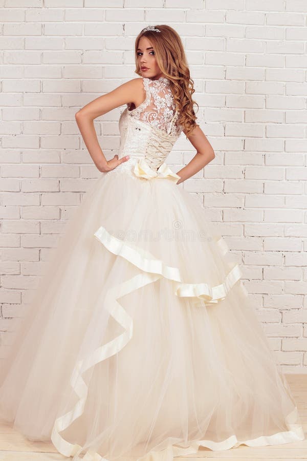 Gorgeous young bride with blond curly hair, wears elegant wedding dress and crown royalty free stock photos Gorgeous young bride with blond curly hair, wears elegant wedding dress and crown royalty free stock photos