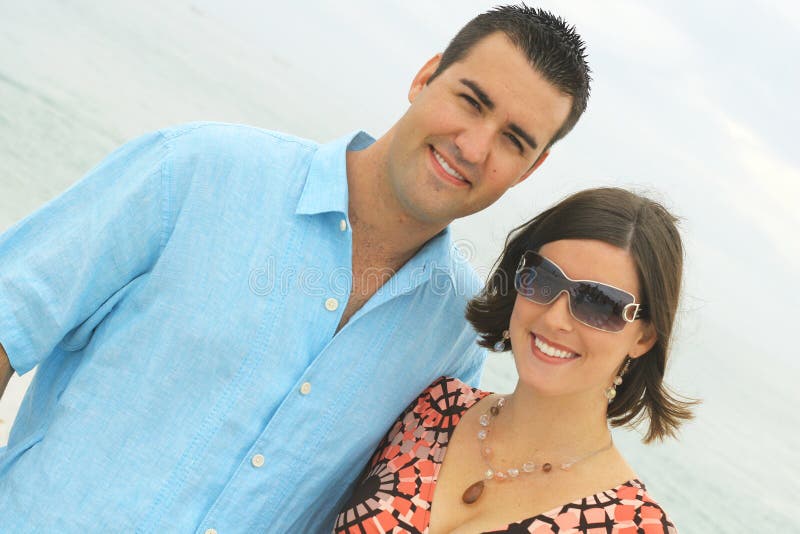 Gorgeous young couple at the beach angle