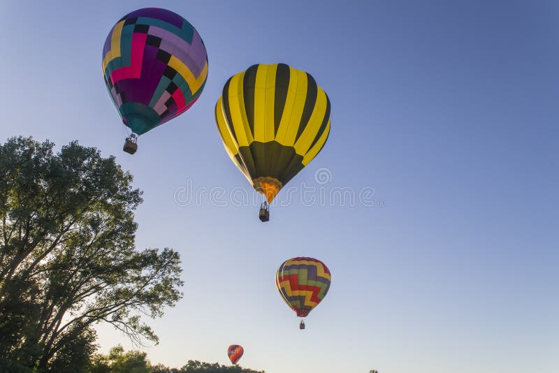 Colorful hot air balloons against a blue sunset sky. Colorful hot air balloons against a blue sunset sky