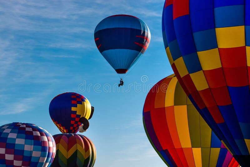 The morning sky is full of vivid colors and bright patterns, as the Labor Day Lift Off hot air balloons take flight over the City. Colorado Springs, CO. The morning sky is full of vivid colors and bright patterns, as the Labor Day Lift Off hot air balloons take flight over the City. Colorado Springs, CO.