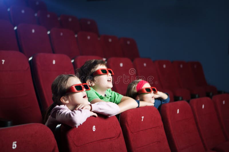 Excited kids watching cartoon in the 3D movie theater. Excited kids watching cartoon in the 3D movie theater