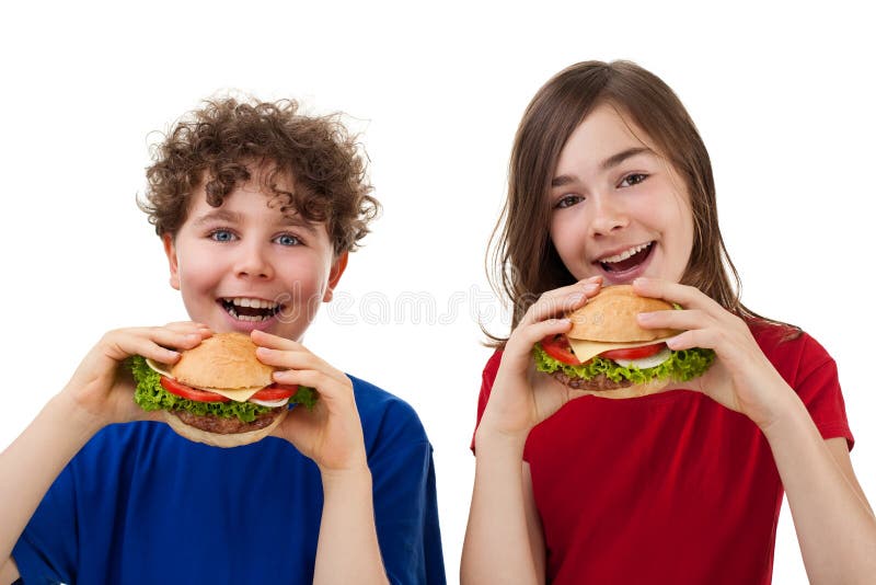 Gosses mangeant les sandwichs sains image libre de droits Gosses mangeant les sandwichs sains image libre de droits