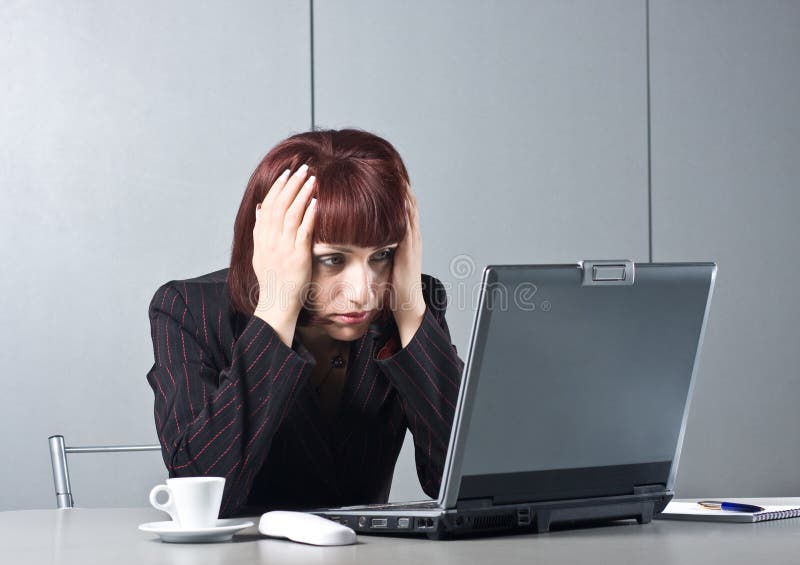 Got tired Beautiful businesswomen behind a desktop