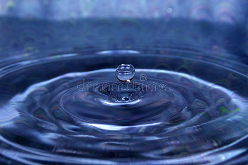 Gota de água azul suspendida fotografia de stock Gota de água azul suspendida fotografia de stock