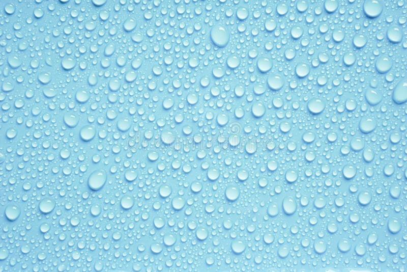 Beautiful big drinking water droplets on the light blue background. Bright blue background. Beautiful big drinking water droplets on the light blue background. Bright blue background.
