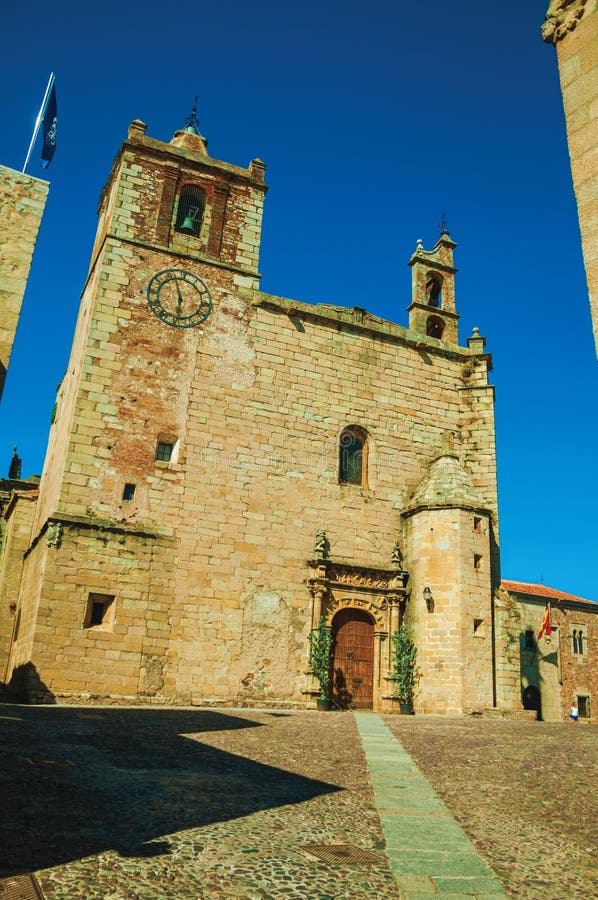 Gothic church facade with steeples and wooden door at Caceres stock image Gothic church facade with steeples and wooden door at Caceres stock image