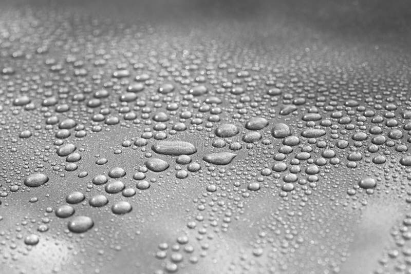 Droplets on a car. Short depth of field. The image may appear grainy, but it's caused by the metallic paint. Droplets on a car. Short depth of field. The image may appear grainy, but it's caused by the metallic paint.
