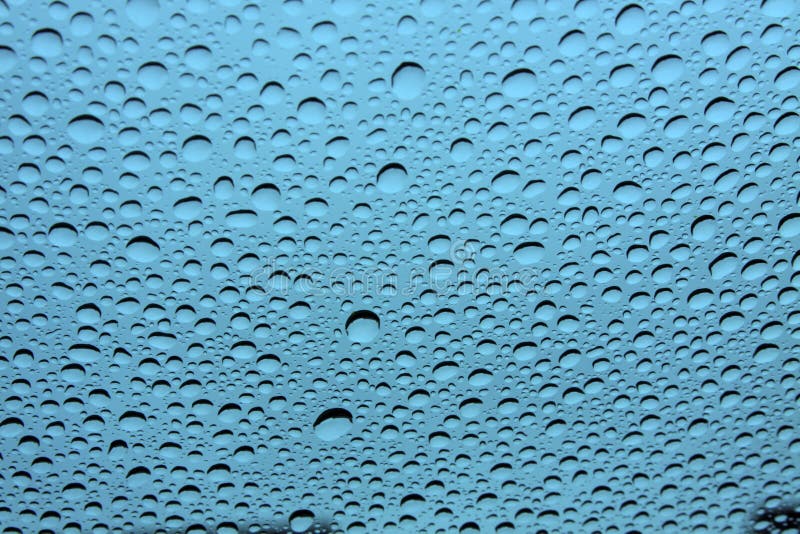 Water droplets on glass with blue background. Water droplets on glass with blue background.