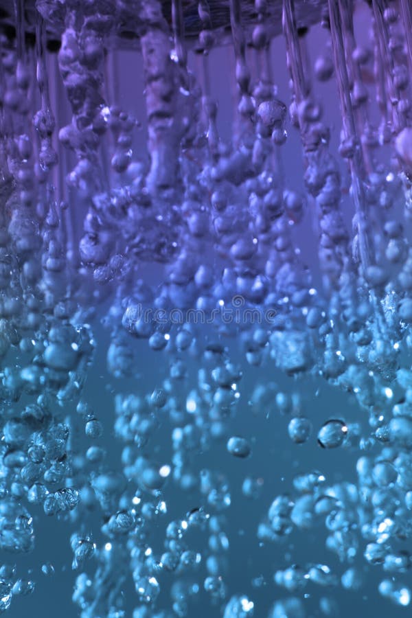 High speed shot of water droplets on blue background. High speed shot of water droplets on blue background