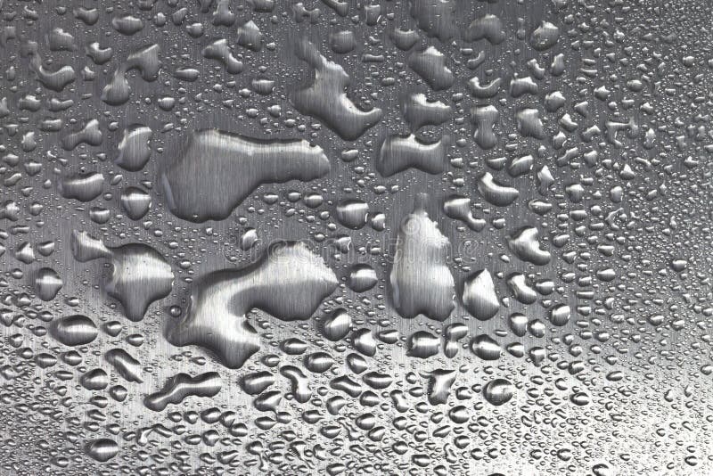 A high resolution image of water and water droplets on brushed metal surface. A high resolution image of water and water droplets on brushed metal surface