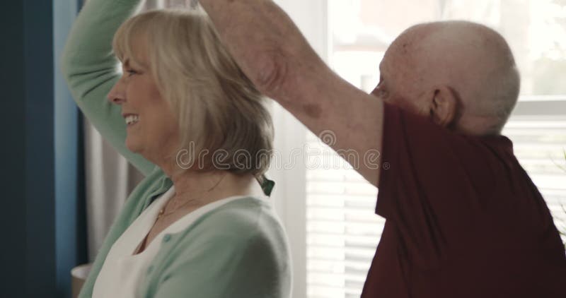 Gott, högt par dansande och snurrande hemma för kärlekens romantik och kvalitetstid tillsammans vid pensionering. Gamle man arkivfilmer
