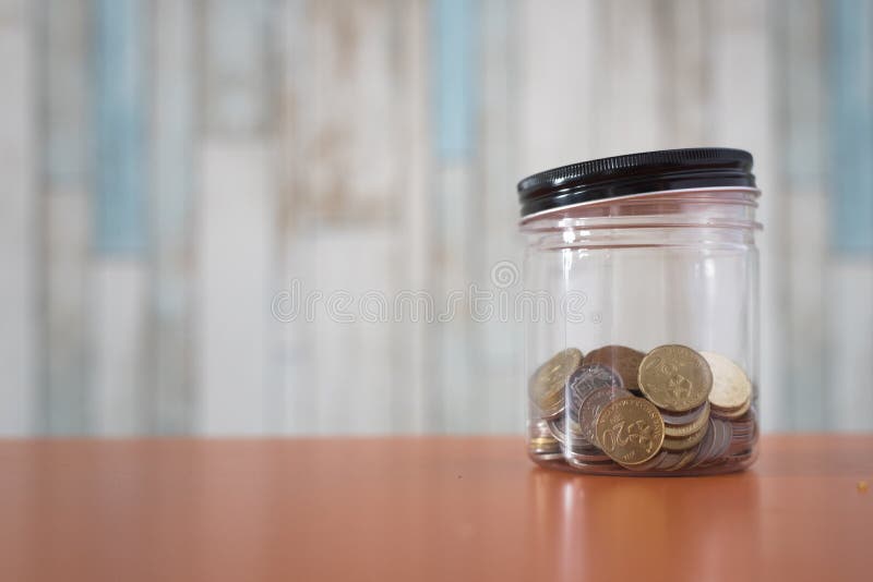 Gouden muntstukken in een plastic kruik royalty-vrije stock foto Gouden muntstukken in een plastic kruik royalty-vrije stock foto