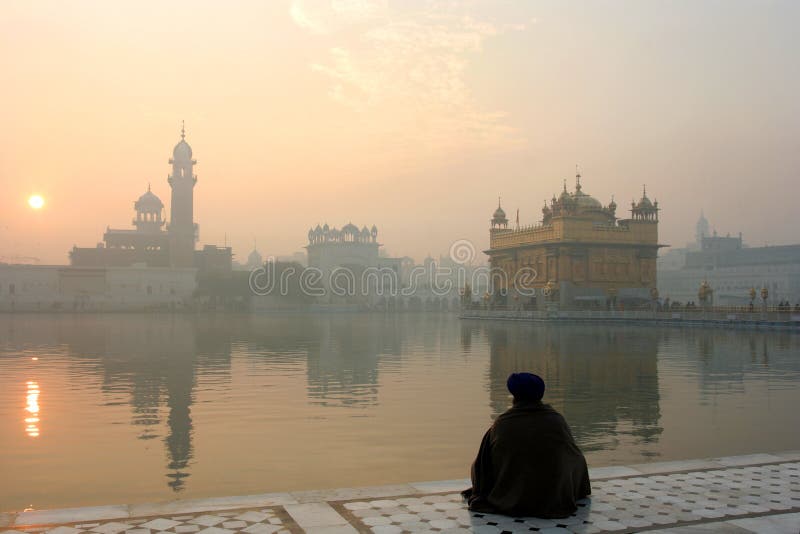 View of the golden temple with a man in meditation, Amritsar, India. View of the golden temple with a man in meditation, Amritsar, India