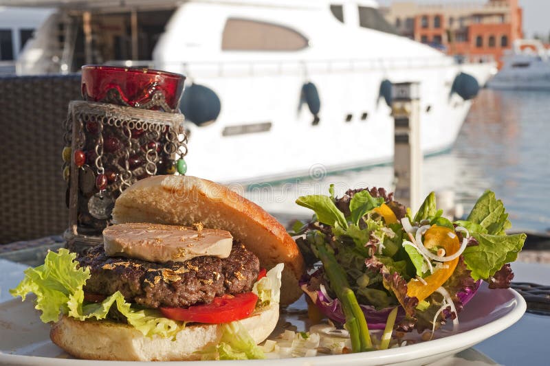 Gourmet burger with salad in a private marina