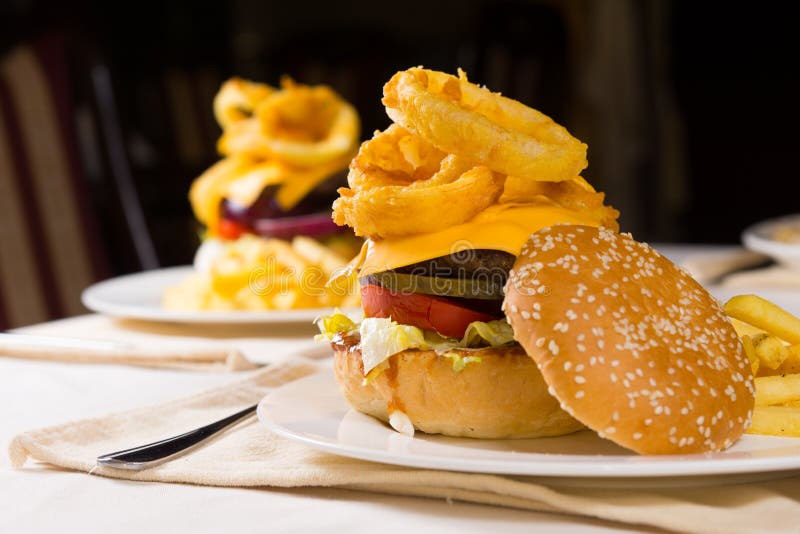 Gourmet Cheeseburgers Piled High with Toppings Stock Photo Image of