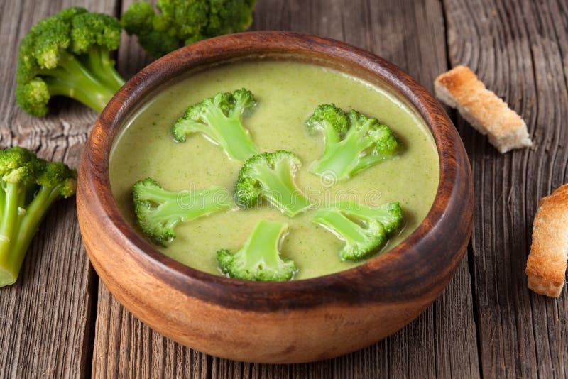 Gourmet cream of broccoli green soup in wooden