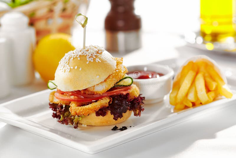 Gourmet, restaurant, delicious dinner food - close up of Sandwich with Deep Fried Fish and Calamari Rings.