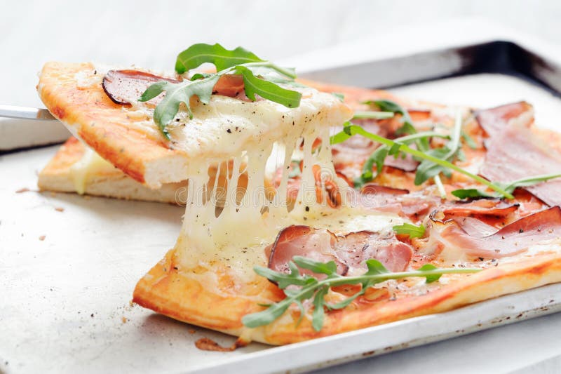 Gourmet Thin Crust Pizza with Fresh Rocket and Caramelised Onion Stock