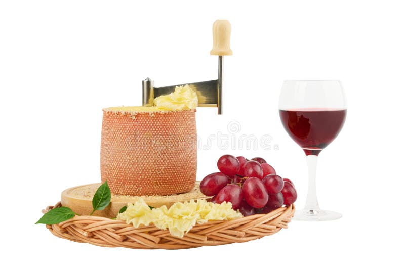 Gourmet tasty cheese Tete de Moine, a glass of red wine and a bunch of grapes isolated on white background